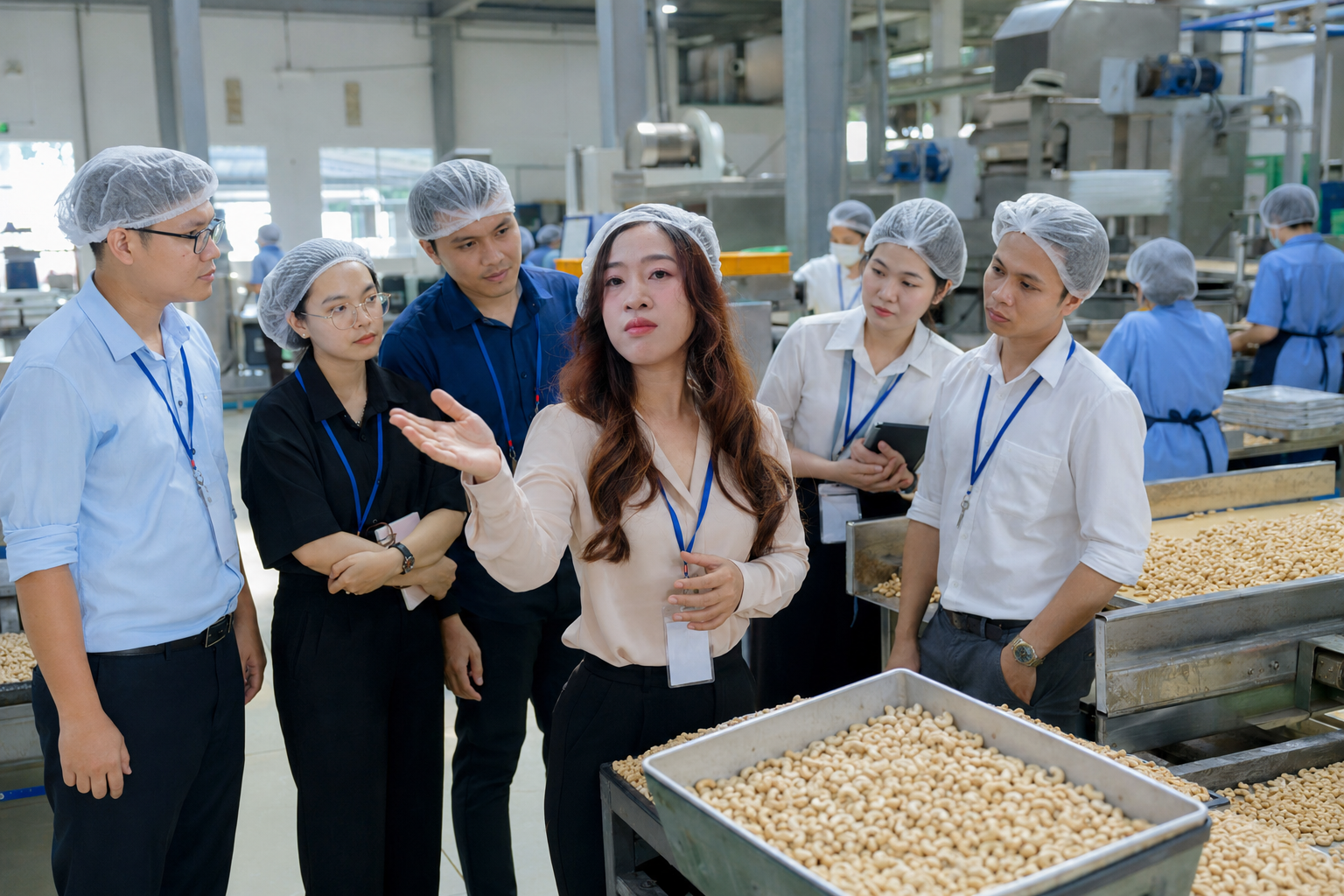 Vietnam Biz Rep representative explaining cashew processing line to overseas buyers during factory inspection